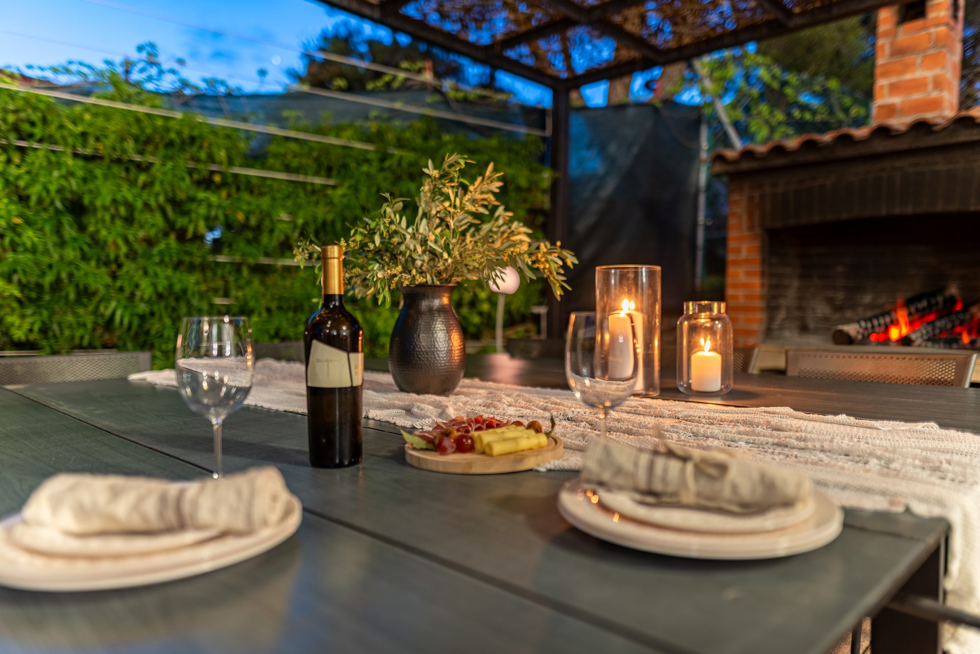 Outdoor BBQ and dining area set for an evening meal at the villa in Zaboric