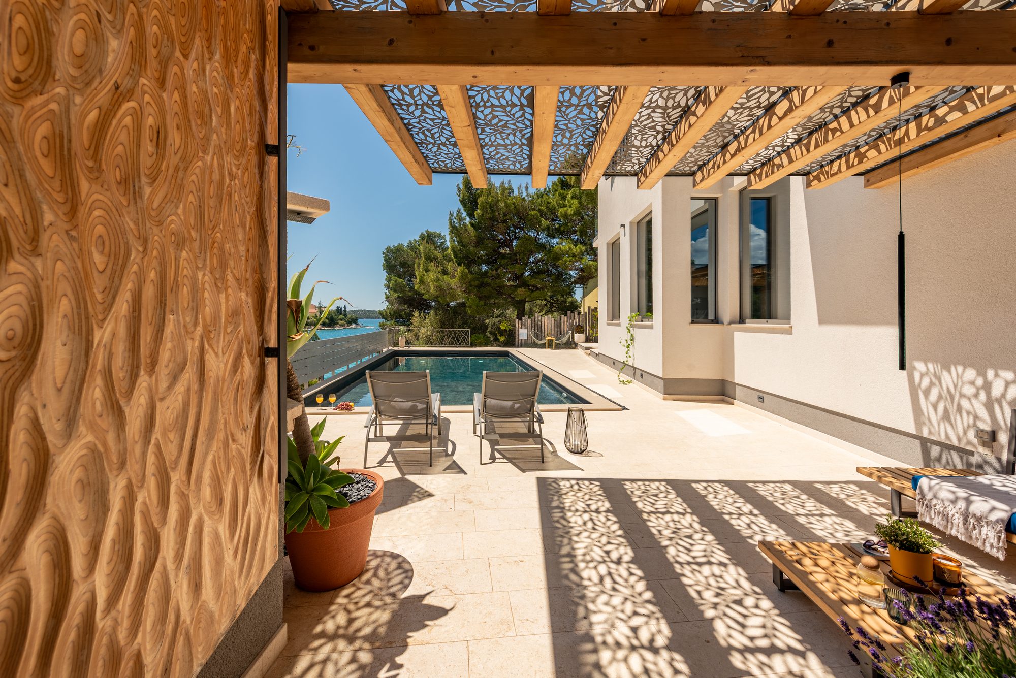 Seafront holiday villa in Zaboric, Croatia, with private swimming pool, sun loungers and pergola overlooking the Adriatic