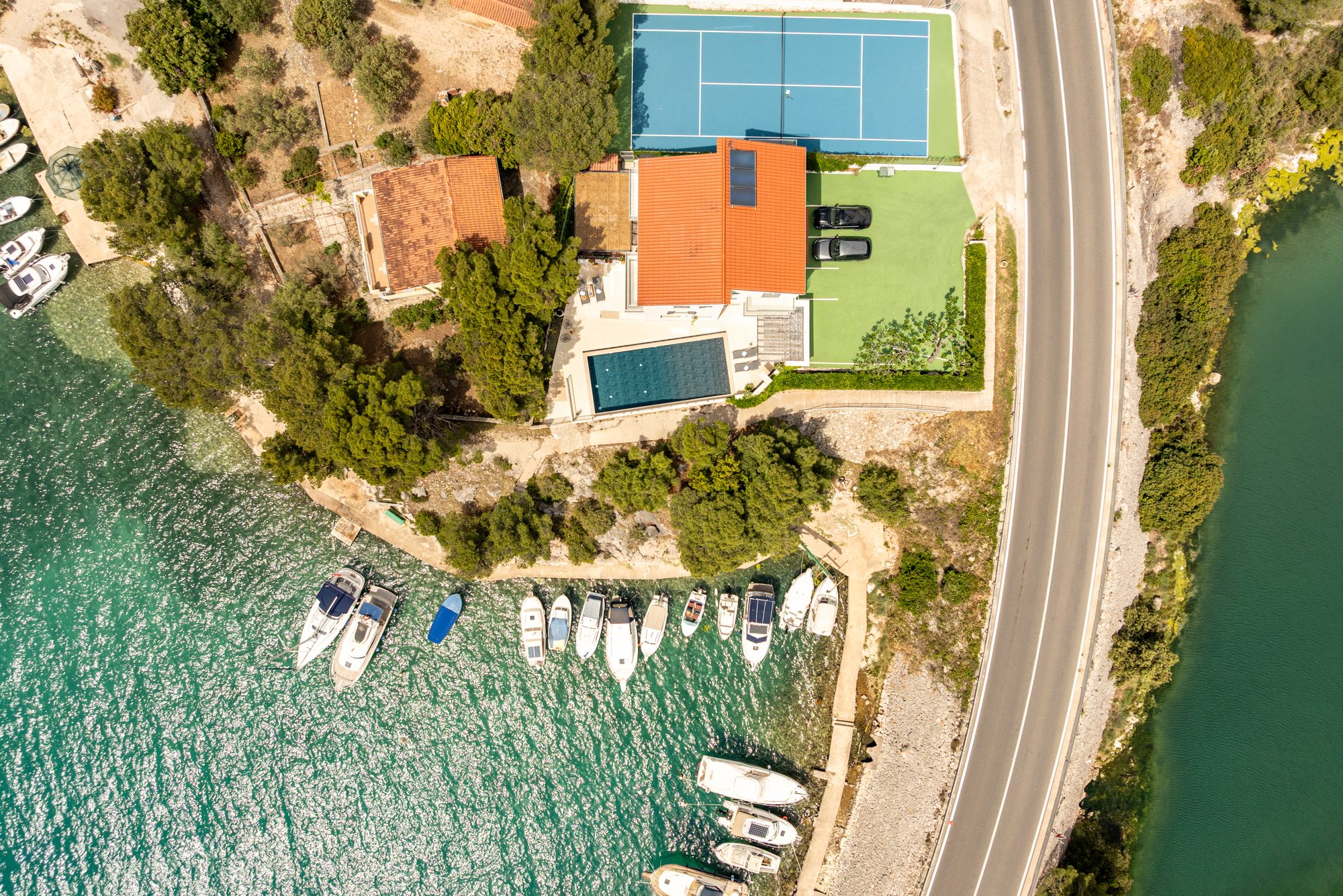 Aerial view of the seafront villa with pool and tennis court beside the sea in Zaboric near Sibenik